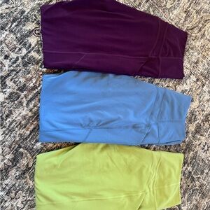 3 Pureluxe Fabletics leggings in Purple, Blue, and Green